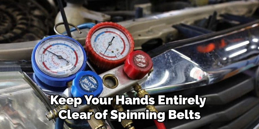 Keep Your Hands Entirely
Clear of Spinning Belts