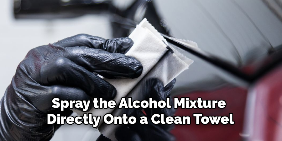 Spray the Alcohol Mixture Directly Onto a Clean Towel