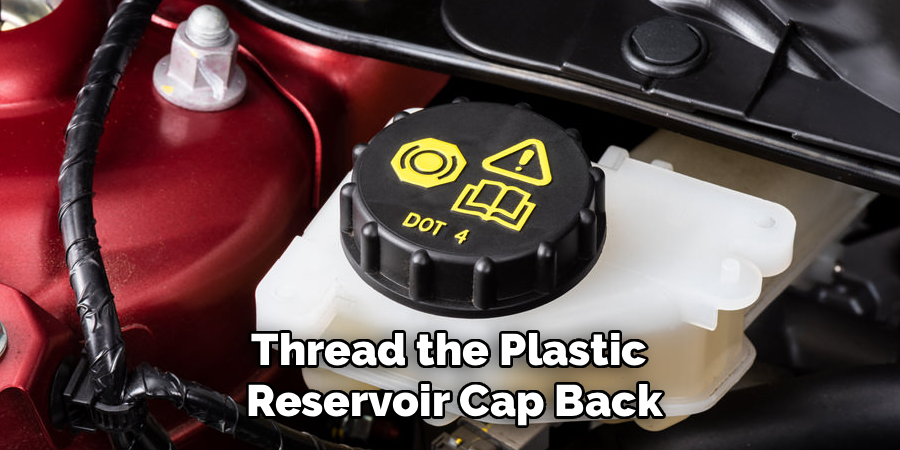 Thread the Plastic 
Reservoir Cap Back